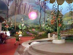 Glinda uses Bubble Travel to narrowly escape a pack of ravenous munchkins.